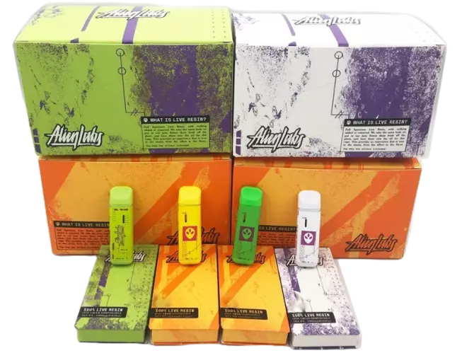 A selection of discreet Alien Labs disposable vapes in vibrant colors, featuring the brand’s logo