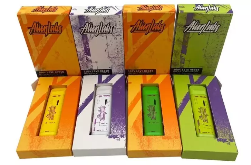 Several Alien Labs live resin vapes. The Alien Lab disposable vapes are still in the boxes and showcase colorful, modern aesthetics.